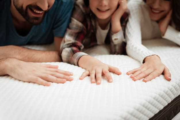 closeup happy family touching mattress store 99043 427